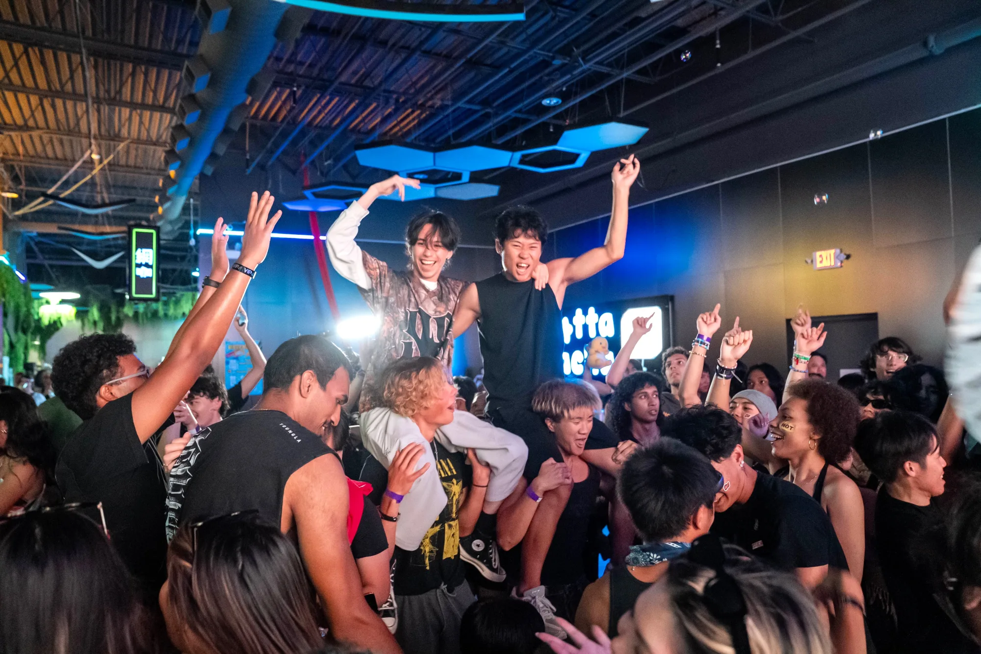 A packed crowd surrounding the DJ booth at Arcade Rave